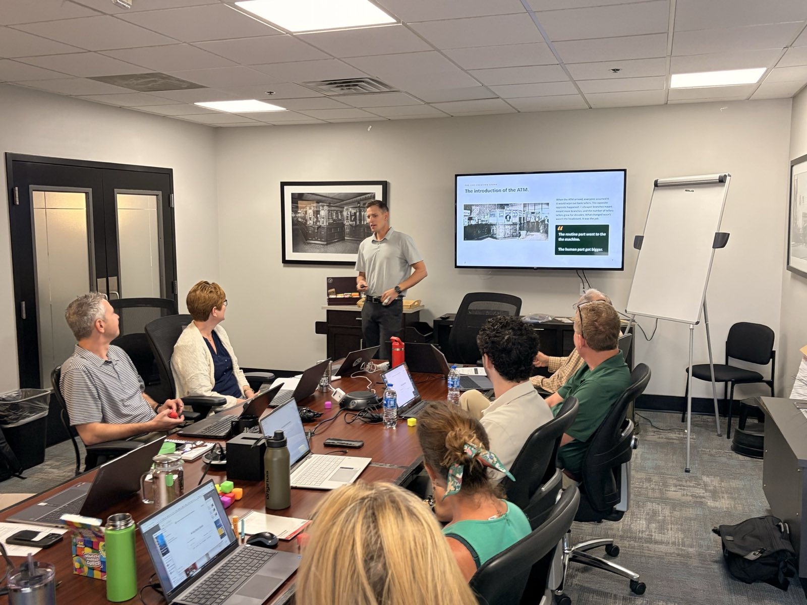 A Fieldwork two-day AI training in a Boise conference room: the facilitator at the screen, the team at their laptops.